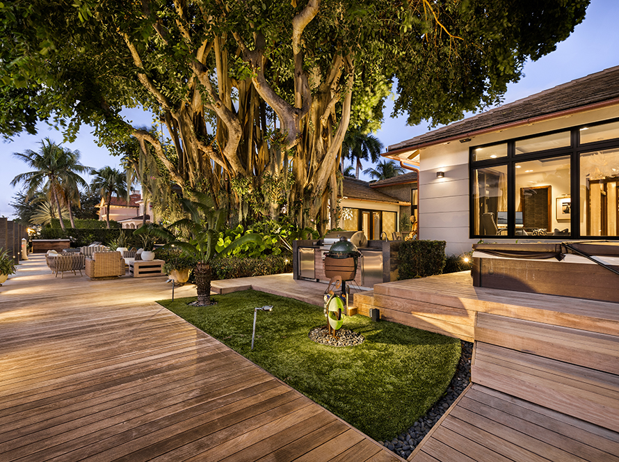 Contemporary Frontdoor Garden Located in Florida, USA, showcasing modern architectural design, wooden furniture, beautiful green Vegetation, Blue sky Clouds and Nature.