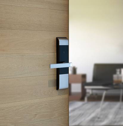 Digital Door handle or Electronics knob for access to room security, Door wooden half opening through interior living room background, selective focus